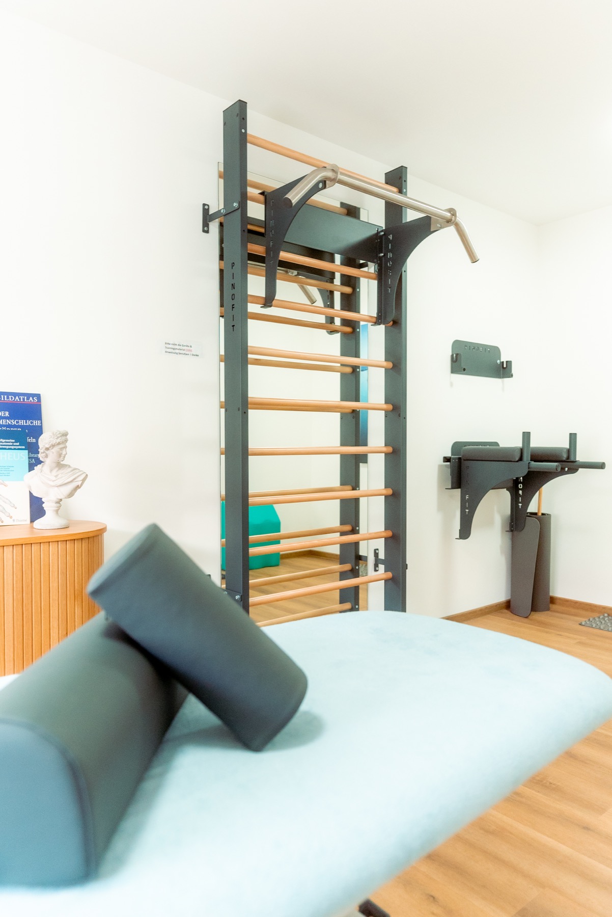 Behandlungsraum der Physiotherapie Vassilios Katsamakidis mit Therapieliege und Trainingswand